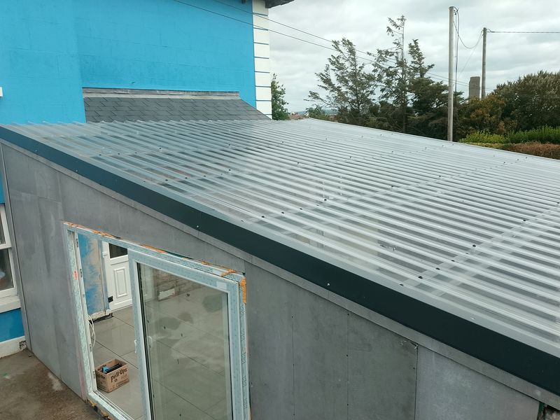 Exterior view of conservatory roof attached to a blue house, Liscannor