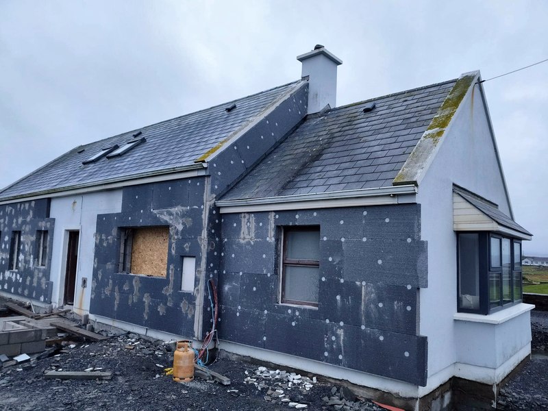 Insulation boards fixed to the outside wall of a house during external wall insulation