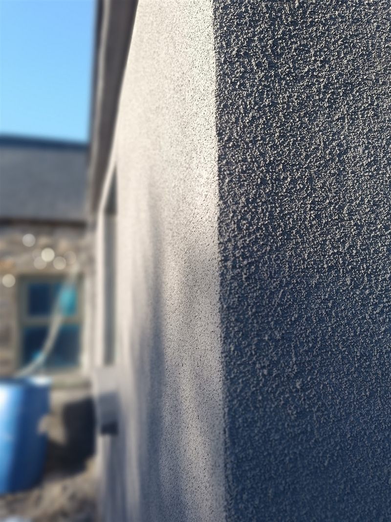 Close-up of a grey textured render finish on an external corner
